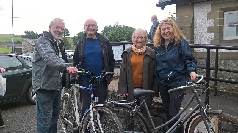 Two bikes being handed over at a Shap Freegle Give and Take